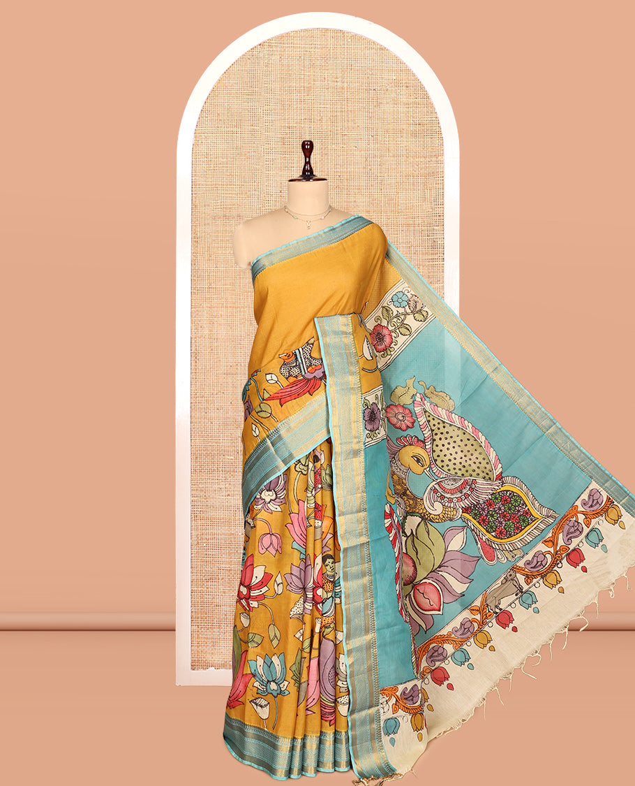 Gold Kalamkari Silk Saree, Impeccably Styled with Floral Vine and Human Motifs Print, a Contrast Traditional Zari Border, Pallu Features Peacocks, and a Contrast Blouse