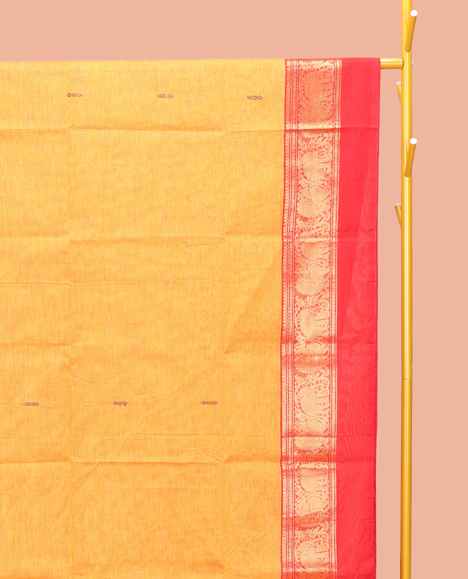 Yellow Chettinad Cotton Saree, Decked Up with Thread Buttas All Over Its Body, Complemented by a Contrast Ganga-Jamuna Kal Eragina Border of Kodi Peacock and Elephant Designs, Pallu of Buttas and Stripes, and Paired with a Matching Blouse