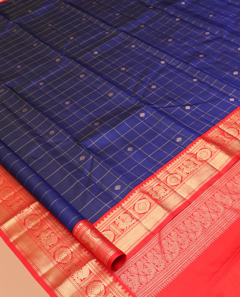 Blue Vasundhara Silk Saree, Adorned with Butta Enclosed Checks, Complemented by a Contrast Border of Mayil Chakram Designs, and a Contrast Blouse