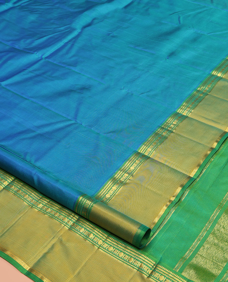 Blue Plain Kanchipuram Silk Saree, Complemented by a Contrast Rettai Pettu Border of Rekku, Banaras, Rudraksham, and Star Designs, Zari Striped Pallu, and Paired with a Contrast Blouse
