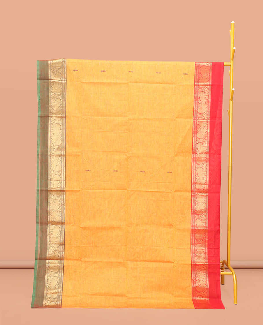 Yellow Chettinad Cotton Saree, Decked Up with Thread Buttas All Over Its Body, Complemented by a Contrast Ganga-Jamuna Kal Eragina Border of Kodi Peacock and Elephant Designs, Pallu of Buttas and Stripes, and Paired with a Matching Blouse