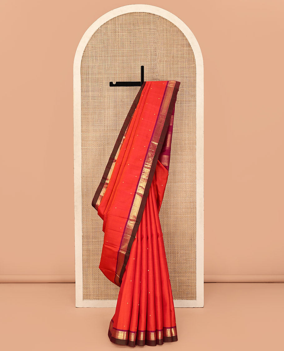 Orange Kanchipuram Silk Saree, Graced with Zari Buttas All Over Its Body, Complemented by Contrast Border of Rekku, Banaras, Neli, and Geometric Designs, Pallu of Traditional Designs, and Paired with a Contrast Blouse