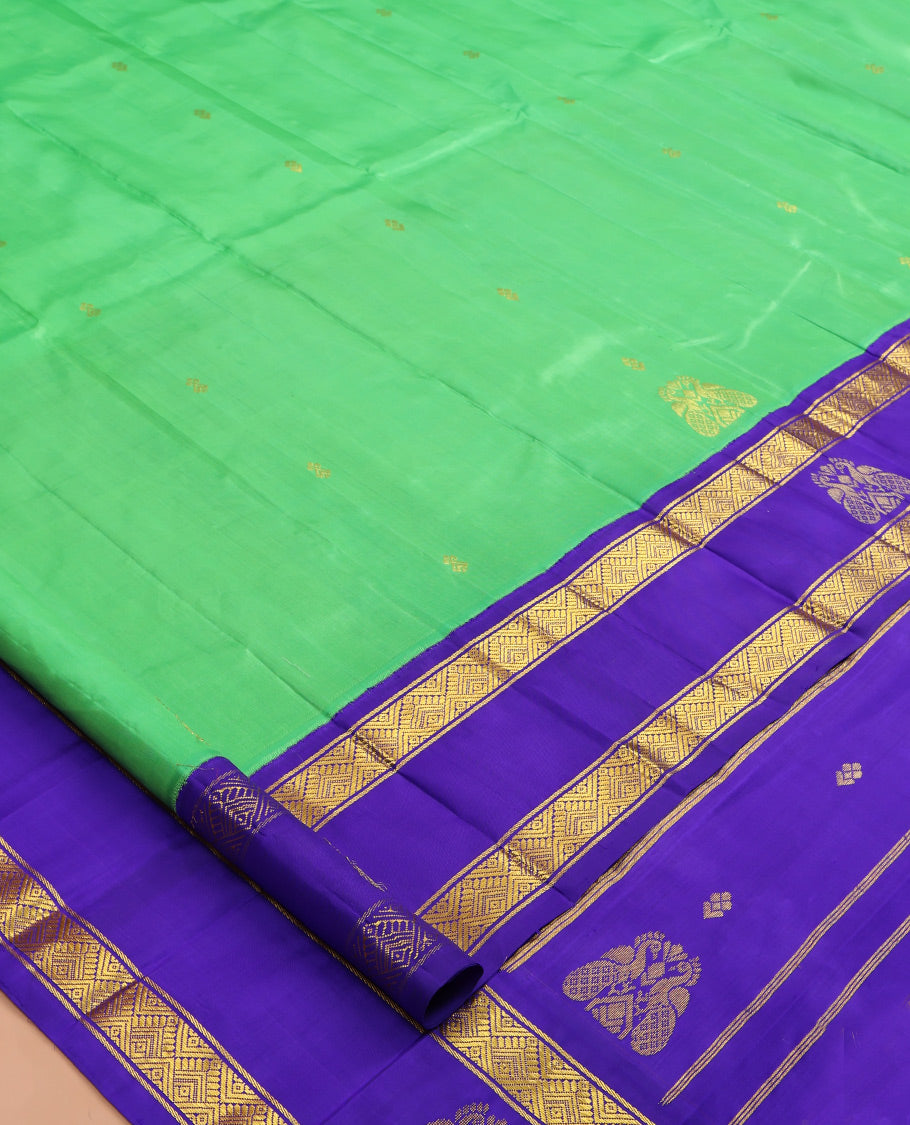 Green Kanchipuram Silk Saree, Woven with Zari Buttas, a Contrast One-sided Korvai Border of Diamond, and Mayil Designs, Pallu of Floral and Paisleys, and No Blouse