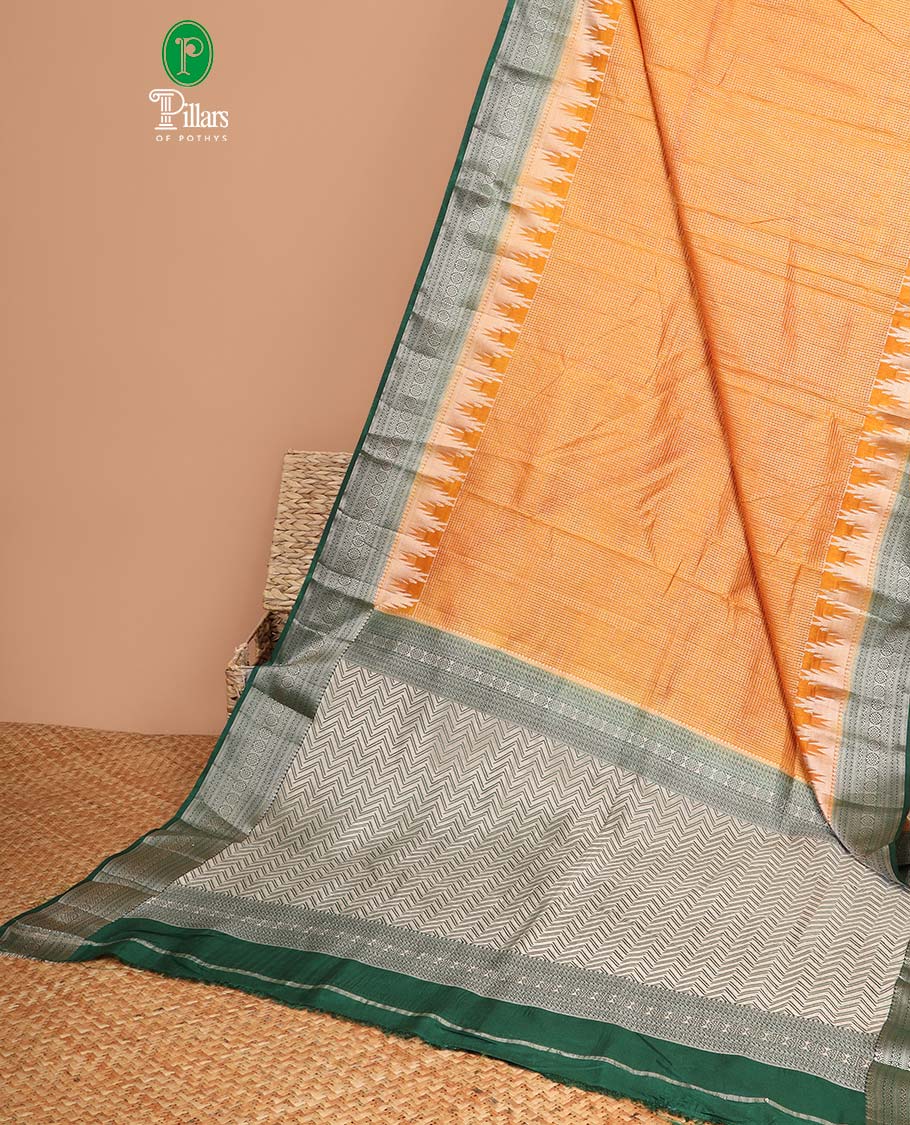 Mustard with green all over small water zari checks with contrast traditional border & contrast zari weaving rich pallu along with zari butta with sequins blouse