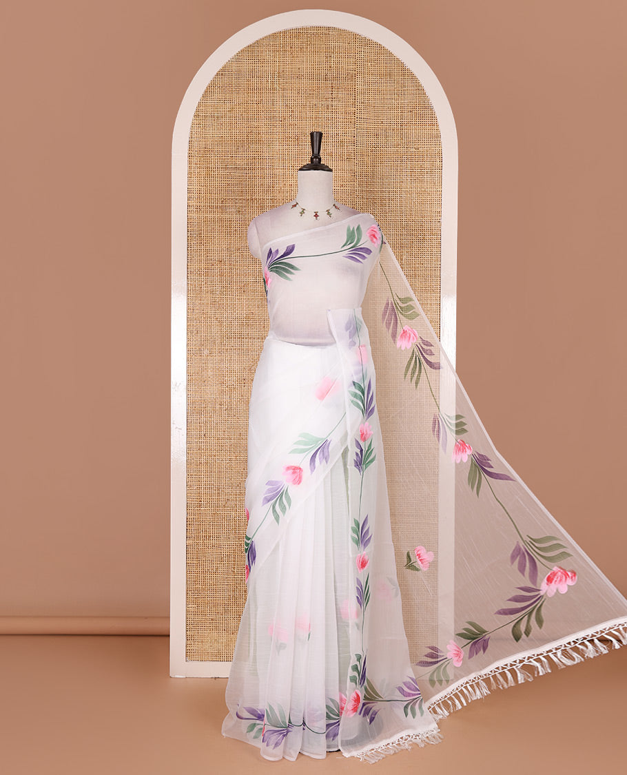 Borderless white floral motifs hand brush painted semi-organza saree comes with tasseled pallu and without blouse