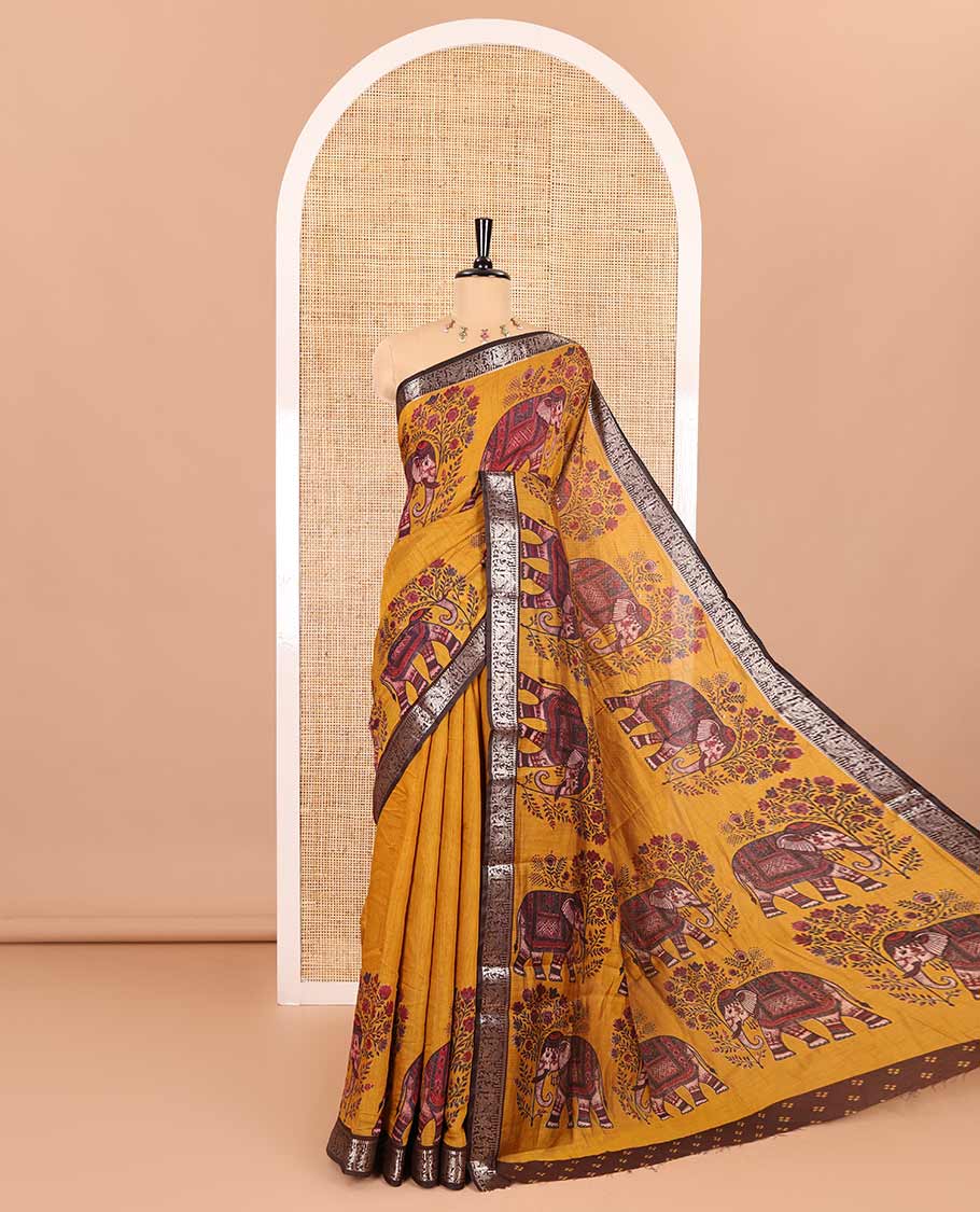 Mustard plain muslin cotton saree, contrast wedding-theme of floral and elephant motifs print, printed pallu, and a contrast buttas and zari bordered blouse