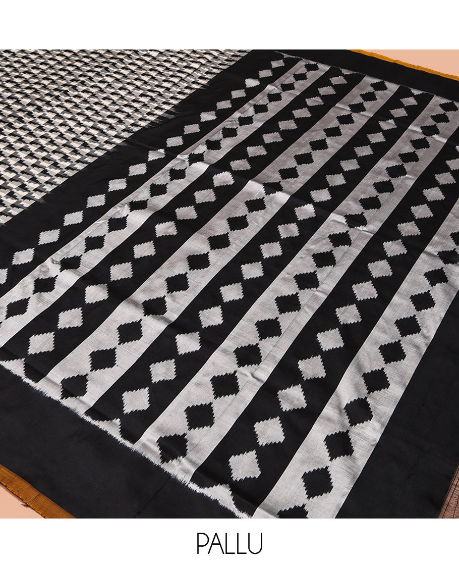 Black and White Pochampally Ikat Silk Saree, Spotlighted with Geometric Patterns on Its Body, Complemented by Contrast Border, Pallu of Diamond Patterns, and Paired with a Contrast Blouse