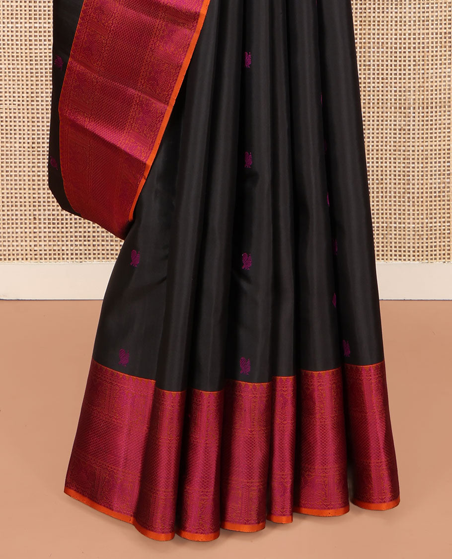 Black Kanchipuram Silk Saree, Masterfully Woven with Mayil-Chakram Buttas All Over Its Body, Complemented by a Contrast Border of Thilakam Mokku, Iruthalai Pakshi, and Kuyil Kann Designs, and Pallu of Jaal Designs, and Paired with a Contrast Blouse