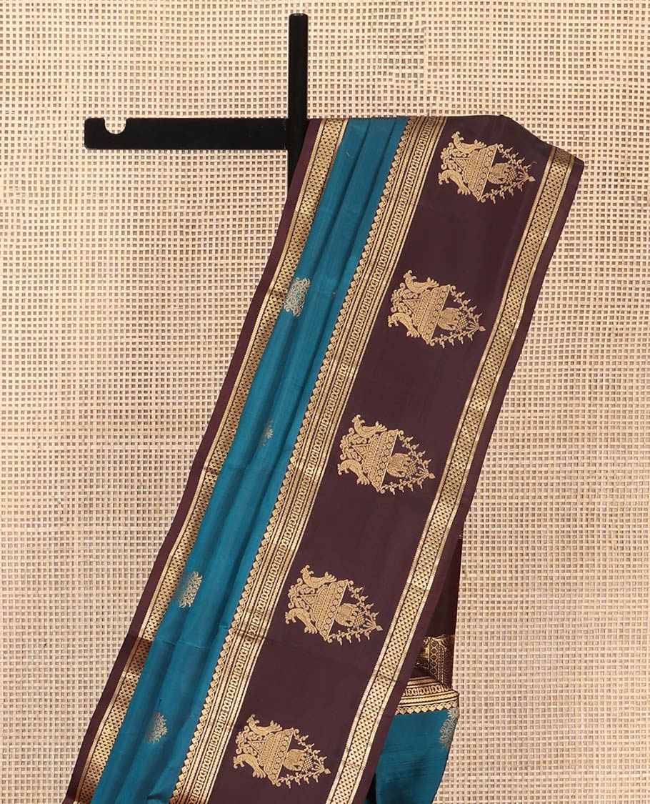 Blue Vasundhara Silk Saree, Elegantly Framed with Zari Buttas All Over Its Body, Complemented by a Contrast Border of Thilakam Mokku, Neli, Kathir, and Ara Maadam Designs, Grand Pallu, and Paired with a Contrast Blouse