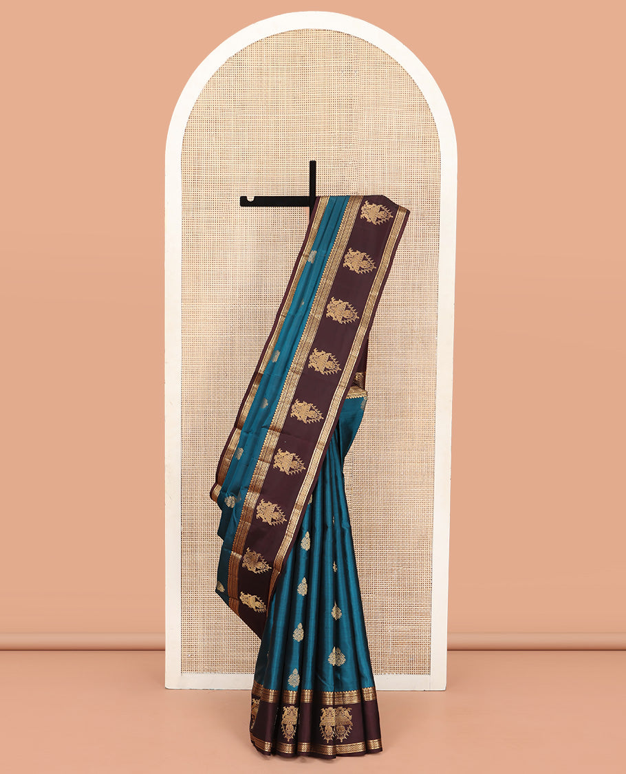 Blue Vasundhara Silk Saree, Elegantly Framed with Zari Buttas All Over Its Body, Complemented by a Contrast Border of Thilakam Mokku, Neli, Kathir, and Ara Maadam Designs, Grand Pallu, and Paired with a Contrast Blouse