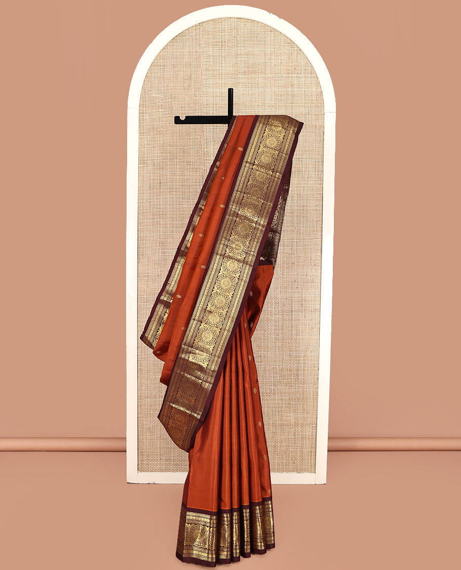 Orange Kanchipuram Silk Saree, Showcasing Zari Buttas All Over Its Body, Complemented by a Contrast Border of Muthu, Kathir, Kamalam, and Chakram Designs, Grand Jaal Pallu, and Paired with a Contrast Blouse