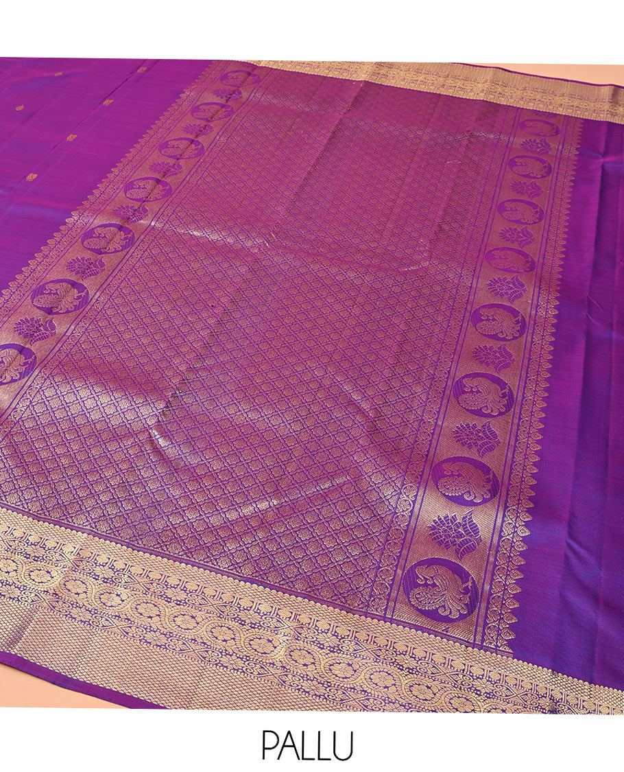 Violet Kanchipuram Silk Saree, Ornamented with Zari Buttas All Over Its Body, Highlighted by Zari Border of Thilakam, Mayil Kann, Poun, Jada Nagam, Dhavana Kodi, and Mayil Kann Designs, Pallu of Jaal Designs, and Paired with a Matching Blouse