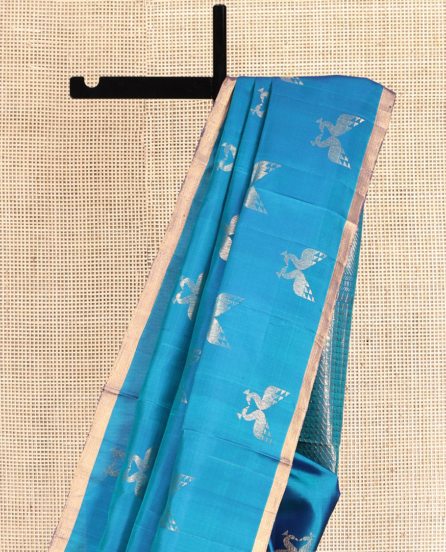 Blue Mayuri Soft Silk Saree, Steeped in the Richness of Mayil Buttas, a Piping Border, Pallu of Ara Maadam Designs, and a Matching Blouse