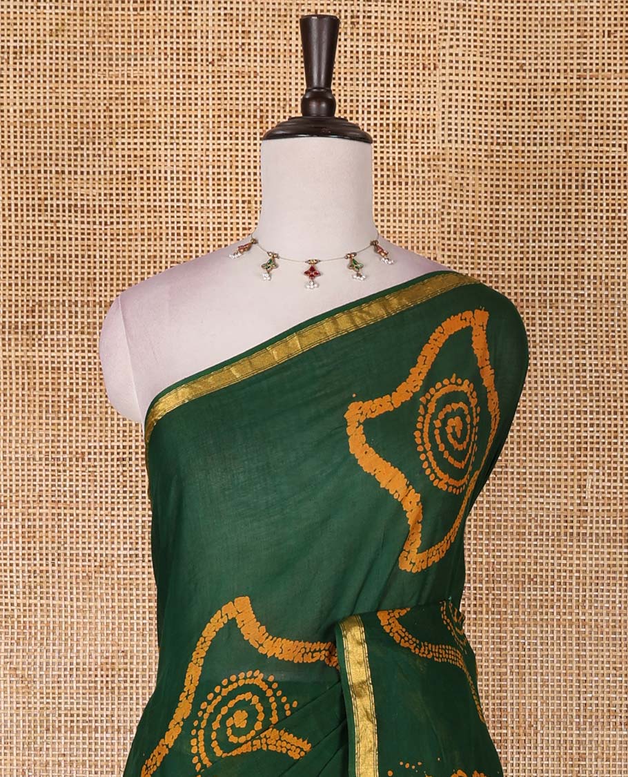 Green batik geometric printed pure cotton saree, zari piping border, human figurines batik printed pallu, and a matching batik printed blouse