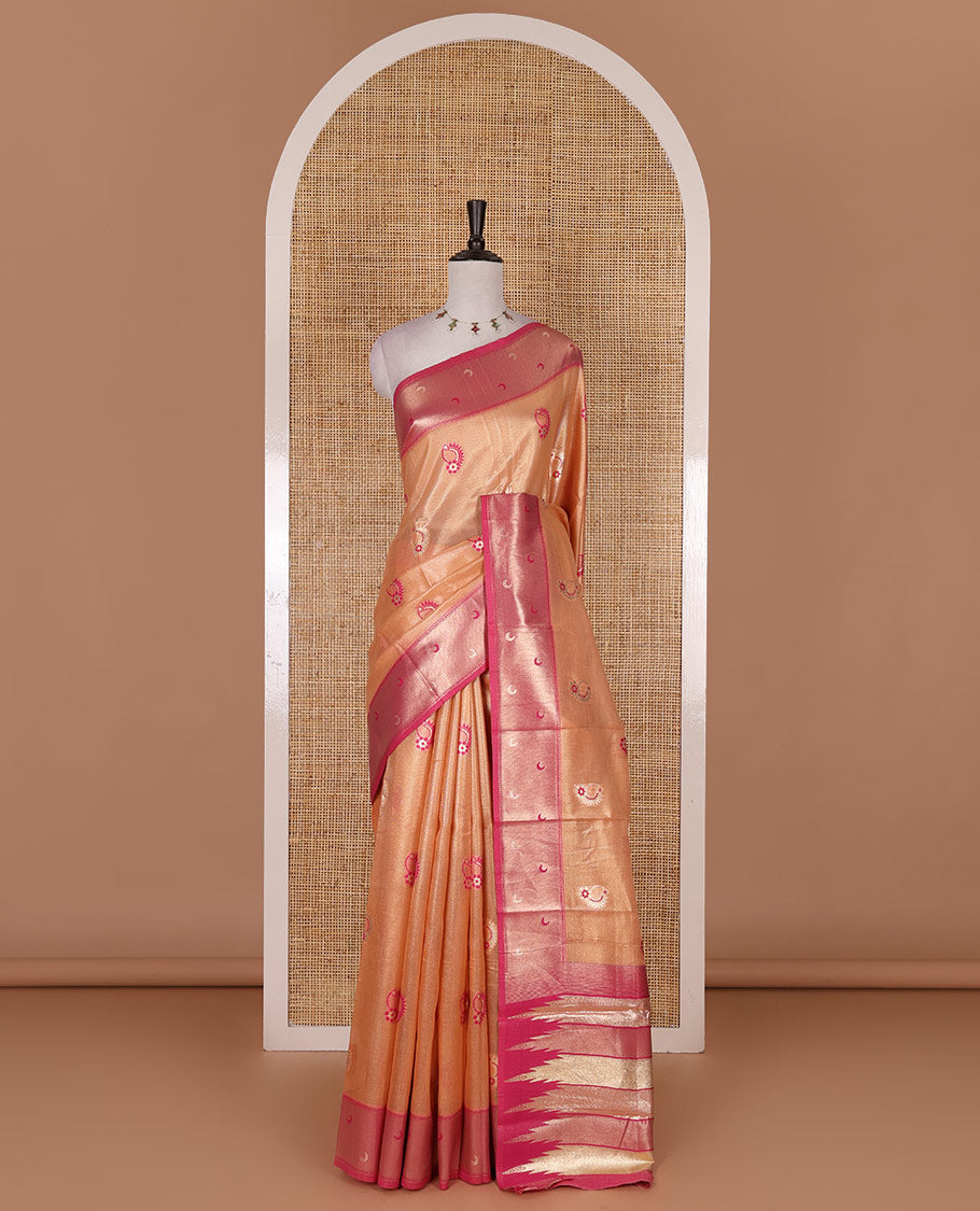 Peach antique buttas tissue silk saree, contrast satin zari border of half-moon motifs, pallu of temple design pallu, and contrast butta blouse