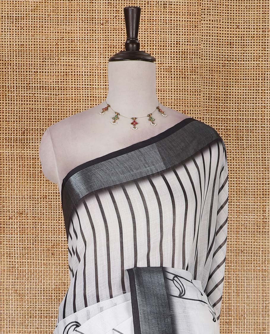 White and black combo printed linen cotton saree features stripes and leaf creeper design, zari border, geometric printed pallu, and contrast printed blouse
