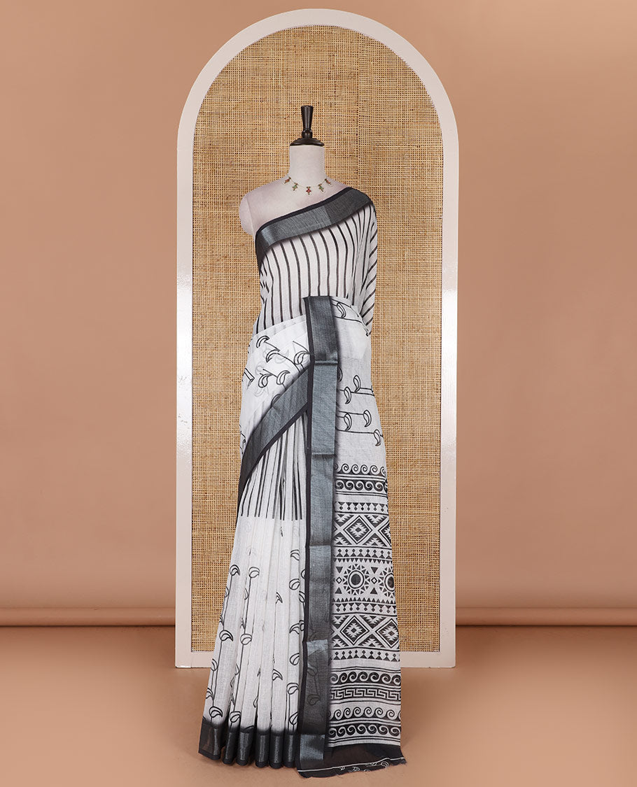 White and black combo printed linen cotton saree features stripes and leaf creeper design, zari border, geometric printed pallu, and contrast printed blouse