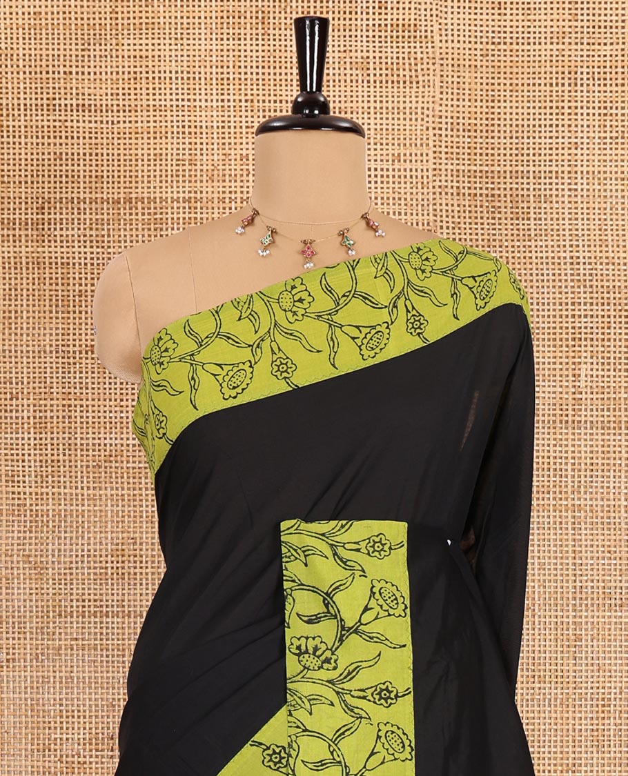 Black plain South cotton saree, contrast block printed border, and pallu of floral vine print, and floral vine printed blouse