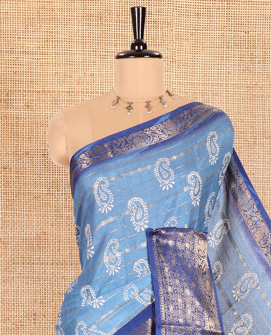 Blue Dola Silk Saree Adorned with Paisley Buttas, and Horizontal Zari Stripes All Over Its Body, Complemented by Contrast Floral Creeper Zari Design Border, Pallu Steeped with Paisleys, and Paired with a Contrast Blouse