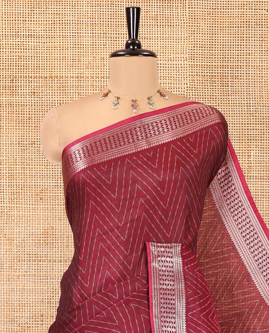 Maroon Dola Silk Saree, Subtly Sparkled with Chevron Stripes on Its Body, Highlighted by Traditional Zari Design Border, Intricately Designed Pallu, and Paired with a Matching Blouse