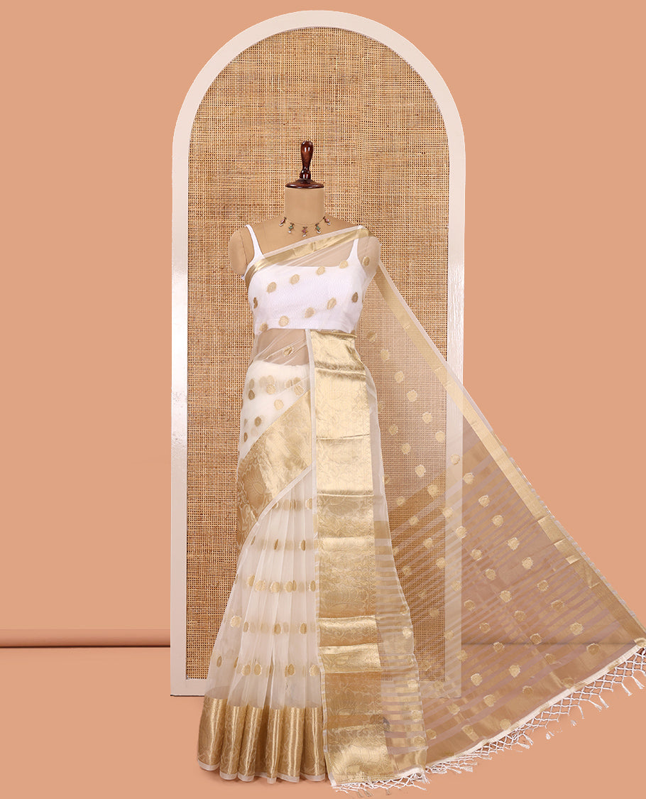 Cream Semi-Organza Saree, Charmingly Accented with Zari Buttas, Highlighted by a Zari Floral Creeper Border, and a Matching Blouse