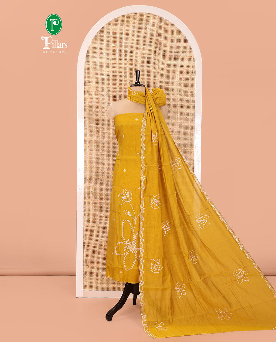 Mustard Mul Chanderi Designer Material Chudidar Set, Meticulously Woven with Big Floral Motifs Embroidered On Its Top, A Plain Santoon Bottom, and Paired with a Mul Chanderi Scallop Thread Embroidered Dupatta