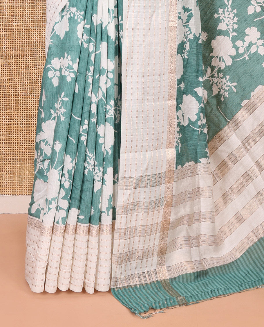 Blue silhouette-style floral discharge printed Assam silk saree, contrast traditional zari border of rudraksham motifs, zari striped pallu, and a floral printed blouse