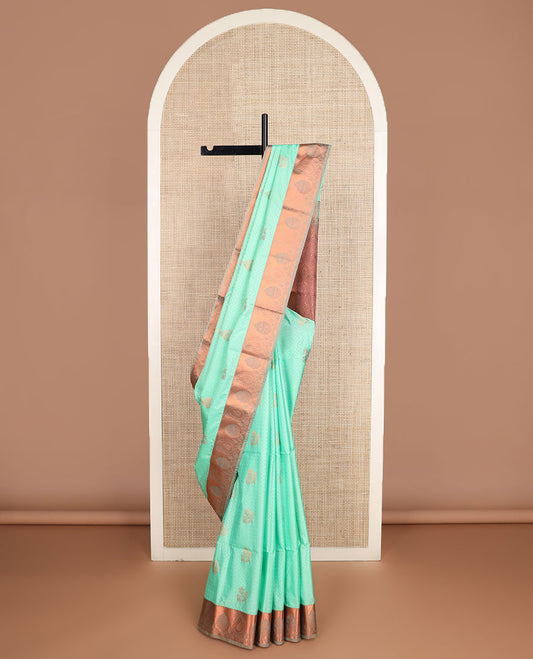 Green embossed and zari buttas soft silk saree, contrast paisley zari design border, and pallu of scallop designs