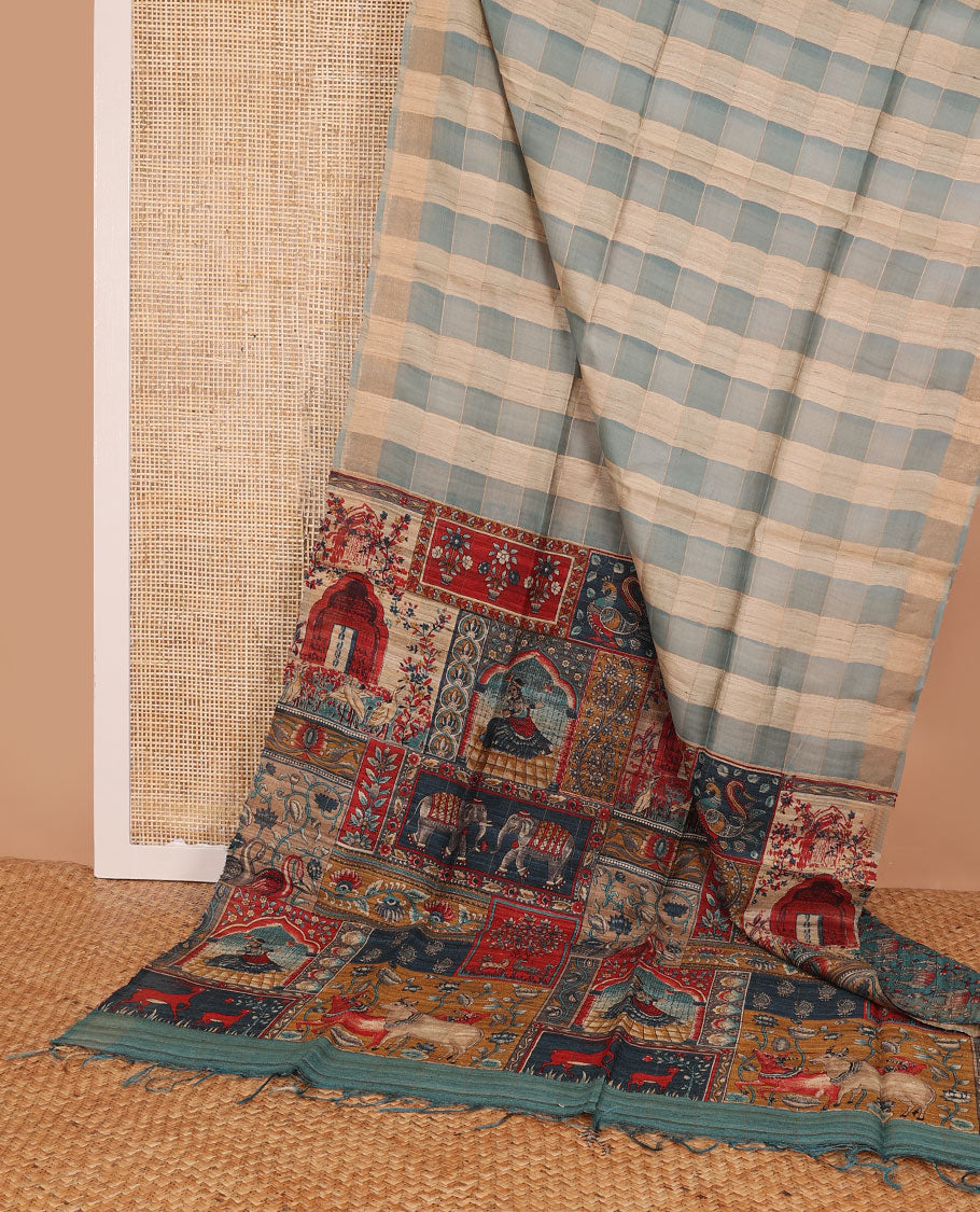 Borderless blue checked tussar saree, contrast pallu pictures pichwai cow, floral creeper, paisley, elephant, dancing kathak girl & swan figurines, with printed blouse