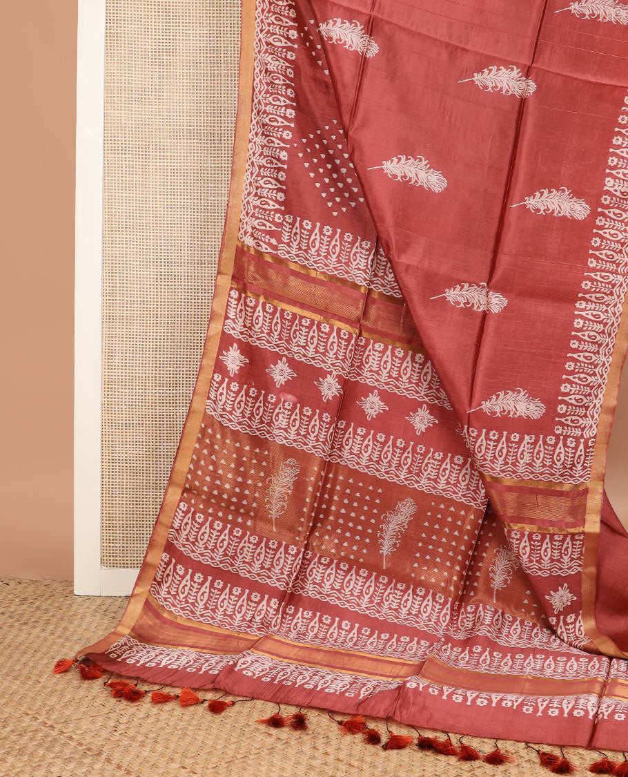 Terracotta red feather motifs printed banana pith saree, zari with print work border, and printed pallu