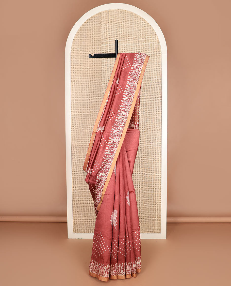 Terracotta red feather motifs printed banana pith saree, zari with print work border, and printed pallu