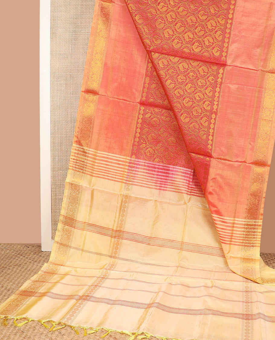 Peach jacquard banana pith saree, traditional zari border, and contrast pallu of stripes