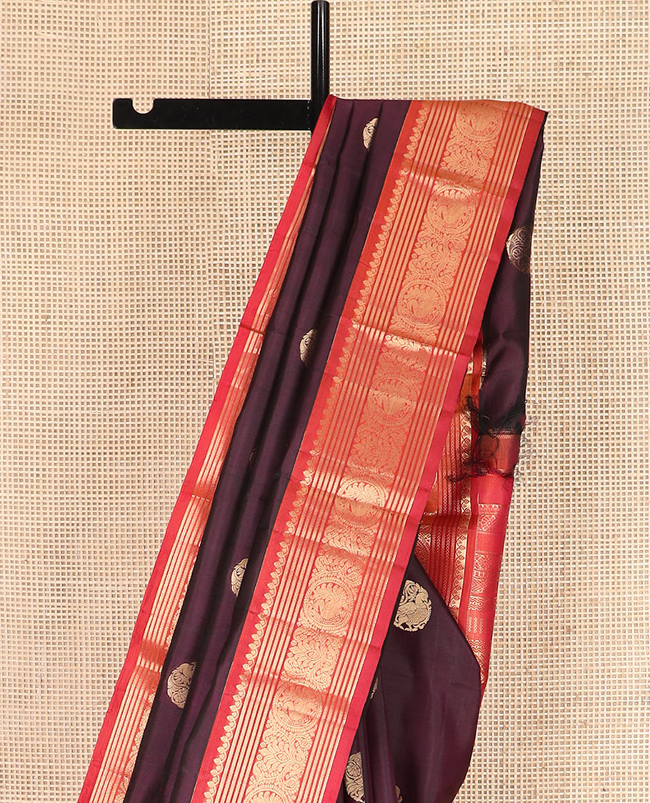 Purple Vasundhara Silk Saree Enthralled with Round Mayil Buttas, Highlighted with a Contrast Border of Thilakam Mokku, Kathir, Banaras, and Mayil Designs, Pallu Decorated with Jaal Design, and Paired with a Contrast Blouse