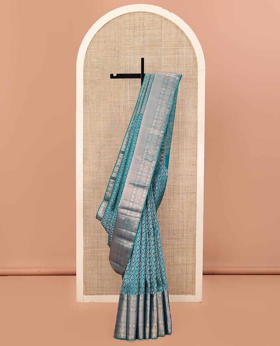 Rama Blue Kanchipuram Wedding Silk Saree, Mesmerized with Jaal Jacquard on Its Body, Highlighted by a Zari Border of Thilakam Mokku, Poun, Mayil, and Kodi Visiry Designs, Grand Pallu Steeped with Chakram Designs, and Paired with a Matching Blouse