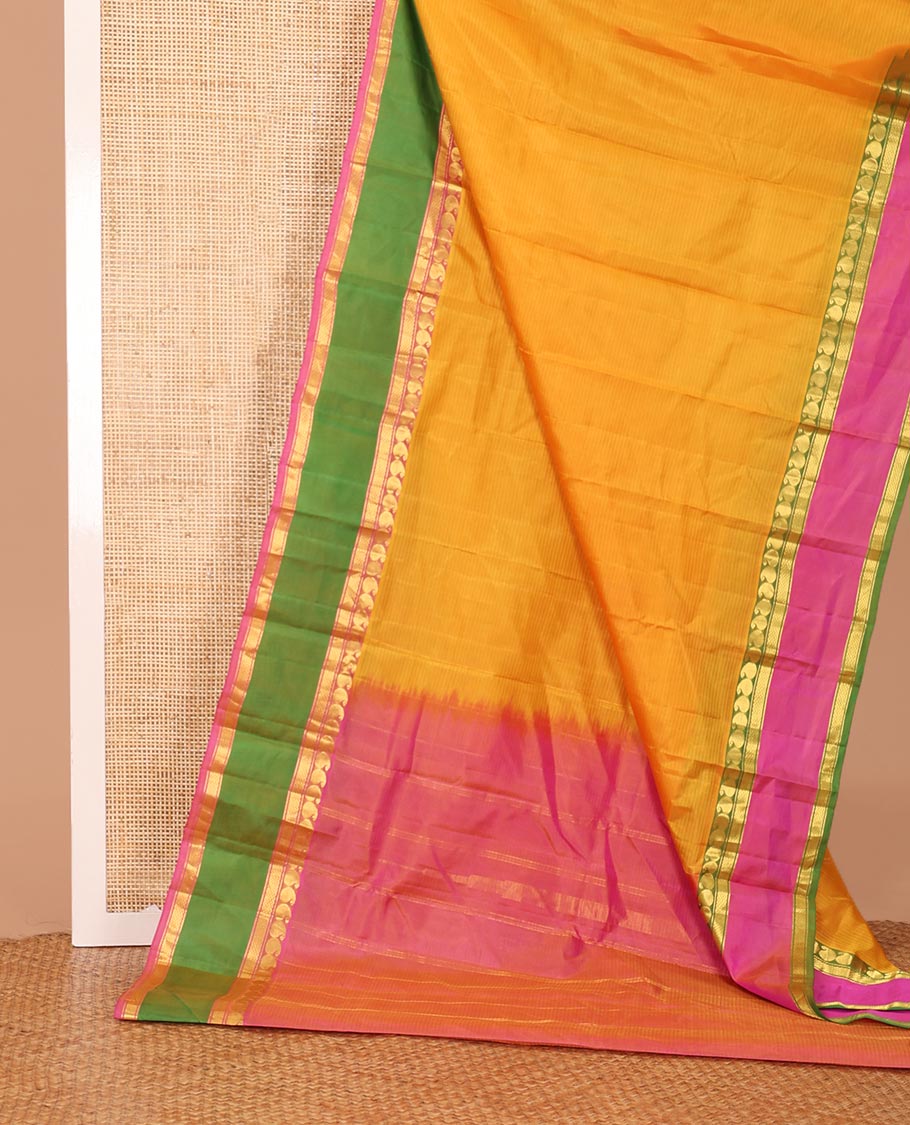 Yellow striped Kanchipuram silk saree, contrast ganga jamuna rettai pettu border of manga, banaras, and mayil kann designs, and zari striped pallu
