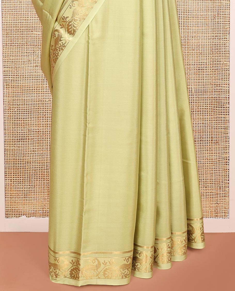 Green Plain Mysore Silk Saree, Highlighted by a Traditional Zari Border of Peacock Designs, Pallu Steeped with Zari Stripes, and Paired with a Matching Blouse
