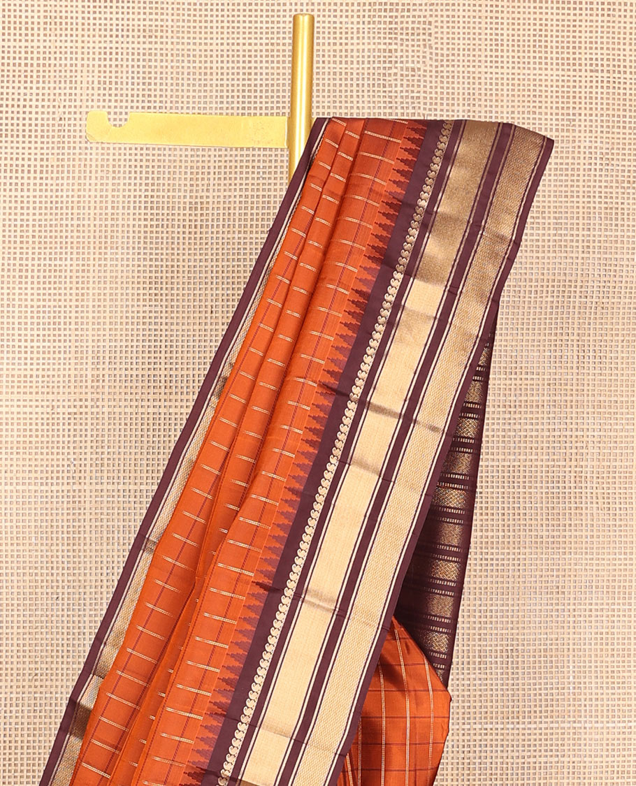 Orange checked Vasundhara soft silk saree, contrast temple border of manga mokku, muthu & mayil kann & zari design pallu