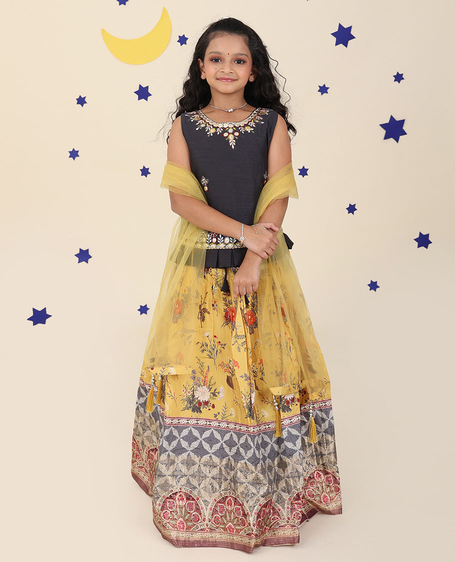 Yellow cholly set features a floral printed skirt, contrast embroidered puff-sleeve blouse & net dupatta