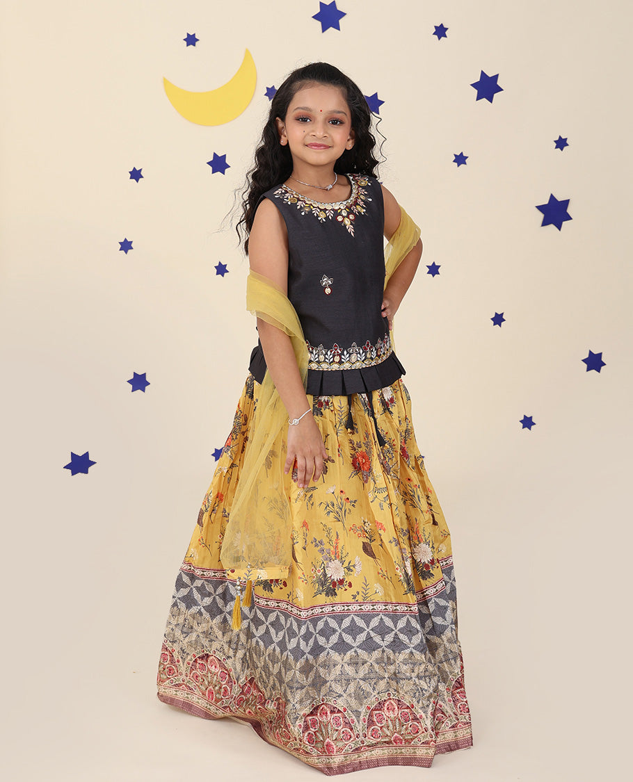 Yellow cholly set features a floral printed skirt, contrast embroidered puff-sleeve blouse & net dupatta