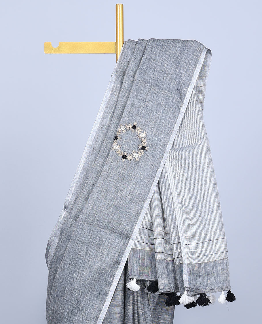 Borderless grey thread embroidered linen saree features floral motifs, pallu of sequin stripes & tassels