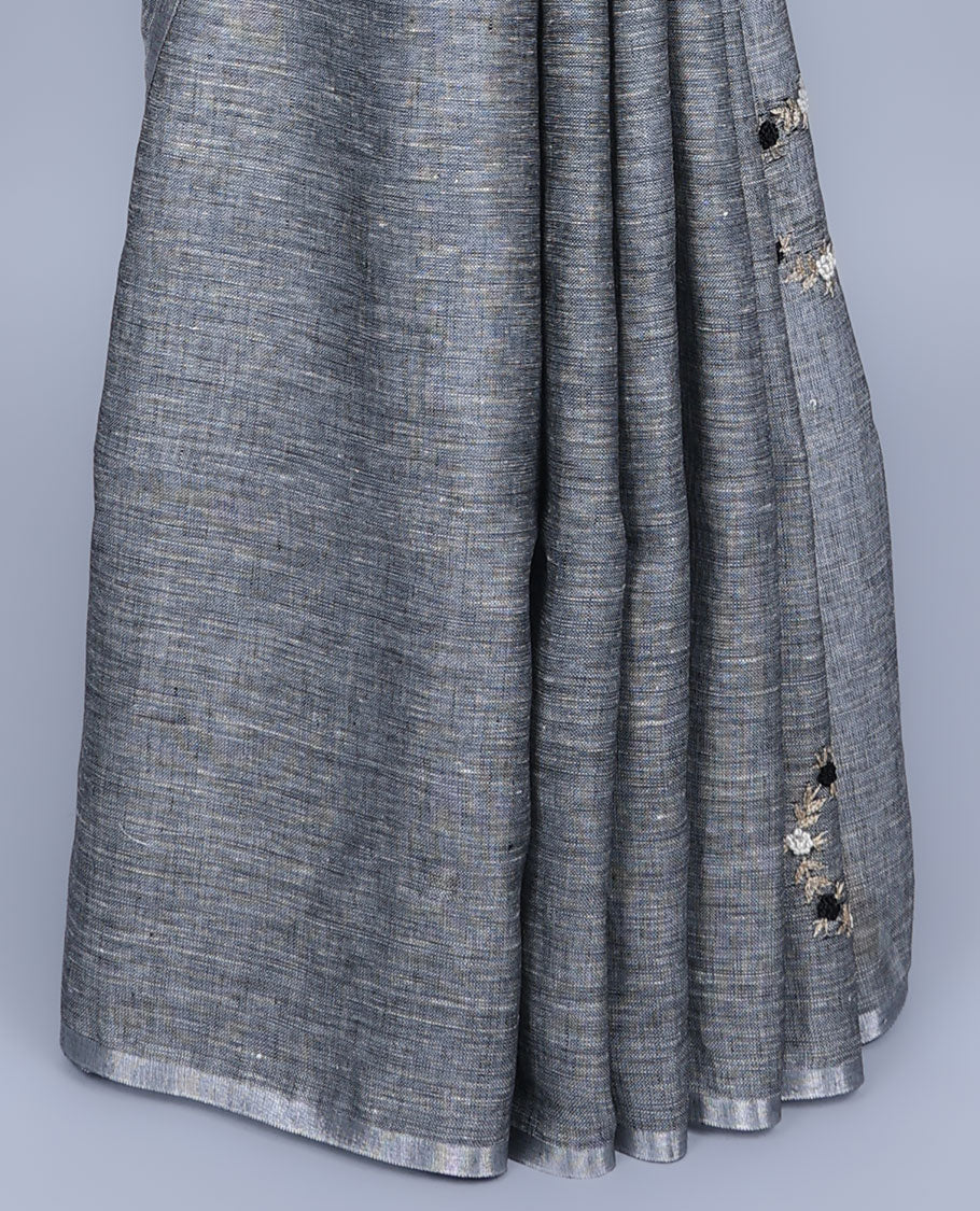 Borderless grey thread embroidered linen saree features floral motifs, pallu of sequin stripes & tassels