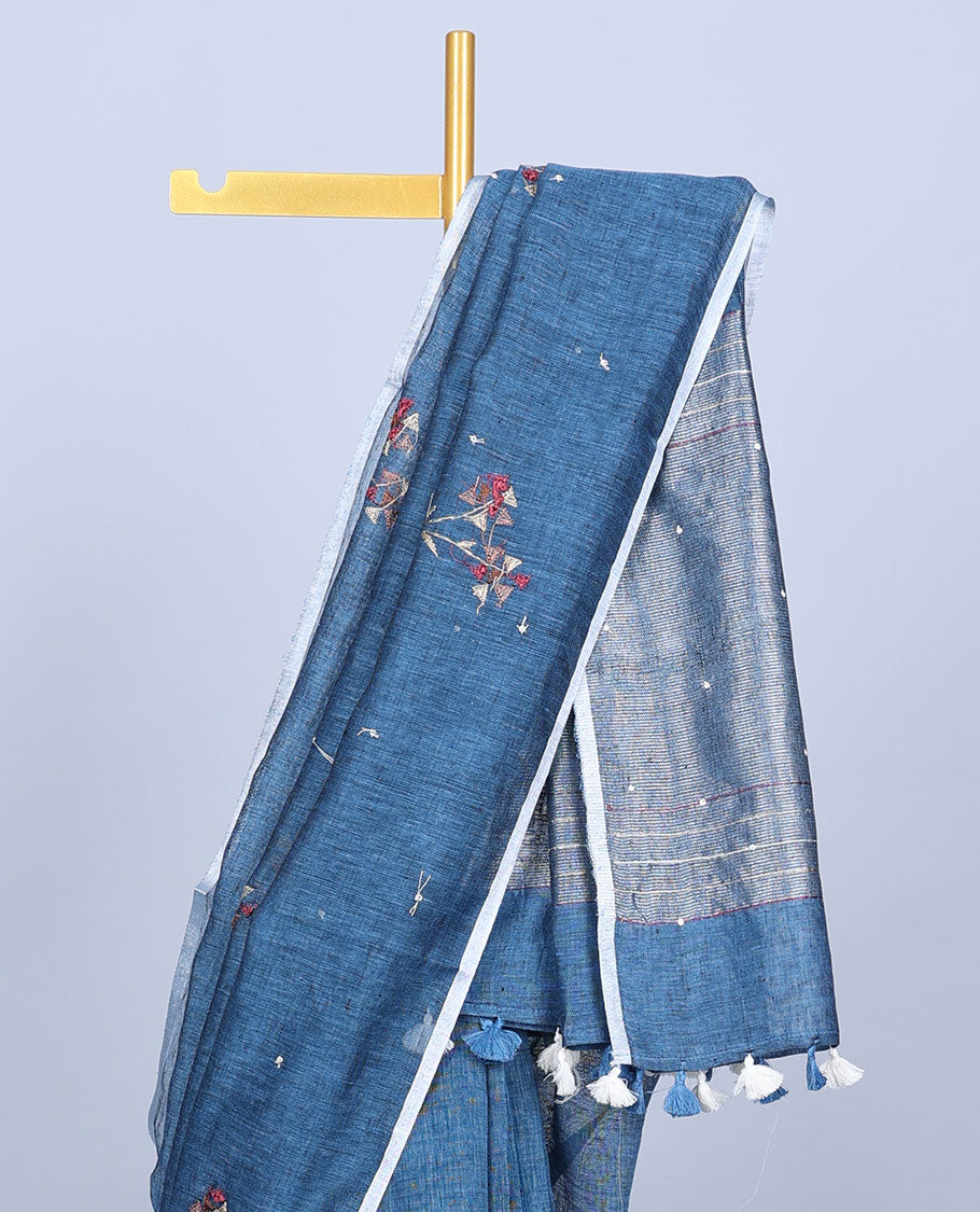 Borderless blue thread embroidered linen saree features floral motifs, pallu of sequin stripes