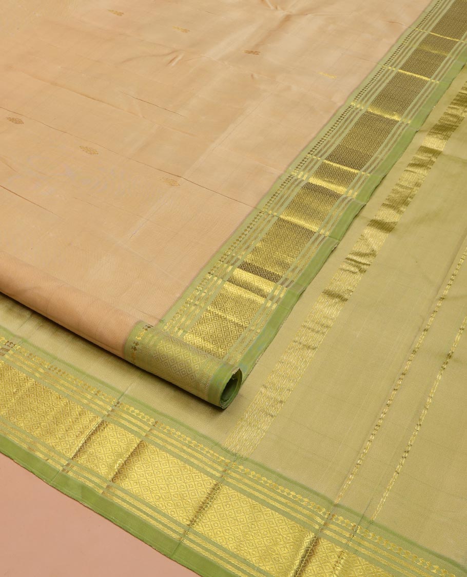 Sandal Kanchipuram Silk Saree, Subtly Sparkled with Thread Buttas on Its Body, Complemented by a Contrast One-Sided Border of Panner Sombu, Banaras, and Mayil Kann Designs, Pallu Features Zari Designs, and Comes Without a Blouse