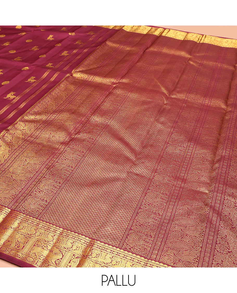 Red Kanchipuram Silk Saree, Lightly Embellished with Kuthirai and Chakram Buttas All Over Its Body, Highlighted by Zari Border of Salngai, Poun, Mayil, Yaali, and Yaanai Designs, Pallu of Ara Maadam Design, and Paired with a Matching Blouse