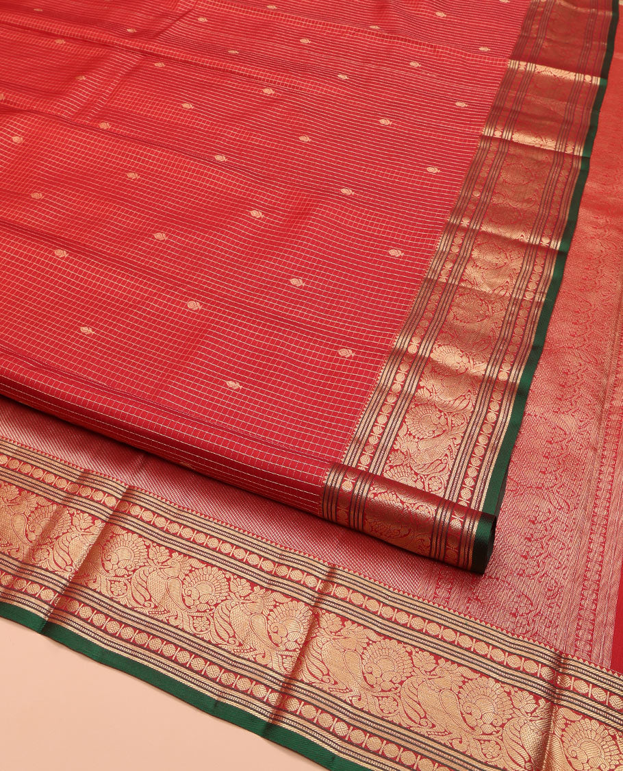 Red Kanchipuram Silk Saree, Richly Detailed with Zari Butta Enclosed Checks on Its Body, Highlighted by Zari Border of Rekku, Poun, Banaras, and Mayil Kann Designs, Diagonally Striped Pallu, and Paired with a Contrast Blouse