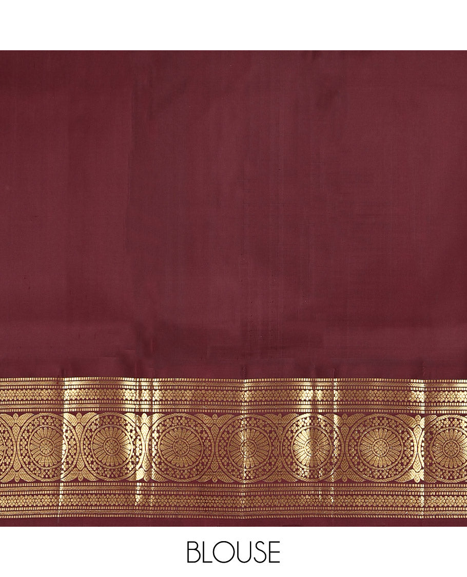 Orange Kanchipuram Silk Saree, Showcasing Zari Buttas All Over Its Body, Complemented by a Contrast Border of Muthu, Kathir, Kamalam, and Chakram Designs, Grand Jaal Pallu, and Paired with a Contrast Blouse