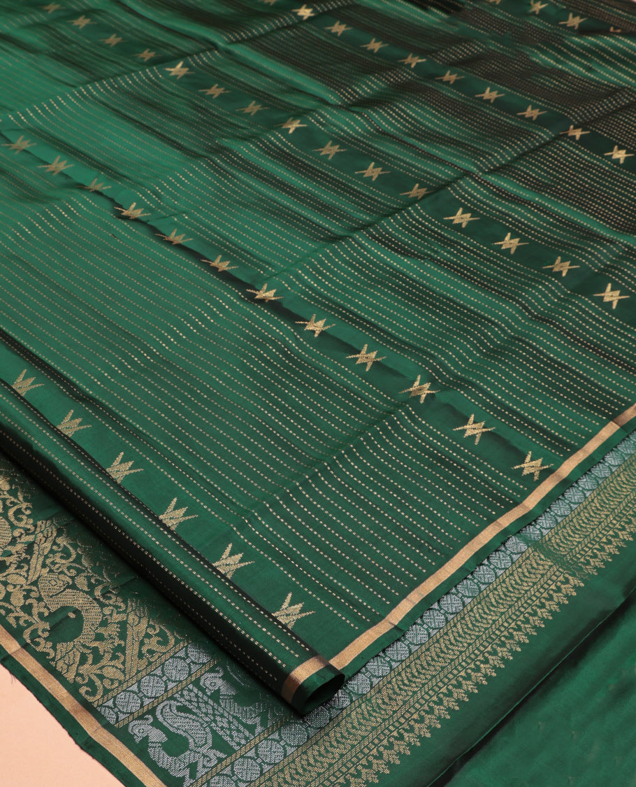 Green Mayuri Lite Silk Mix Saree, Accentuated with Floral Zari Buttas and Muthu Stripes, a Piping Border, a Grand Parrot Motif Pallu, and a Matching Blouse