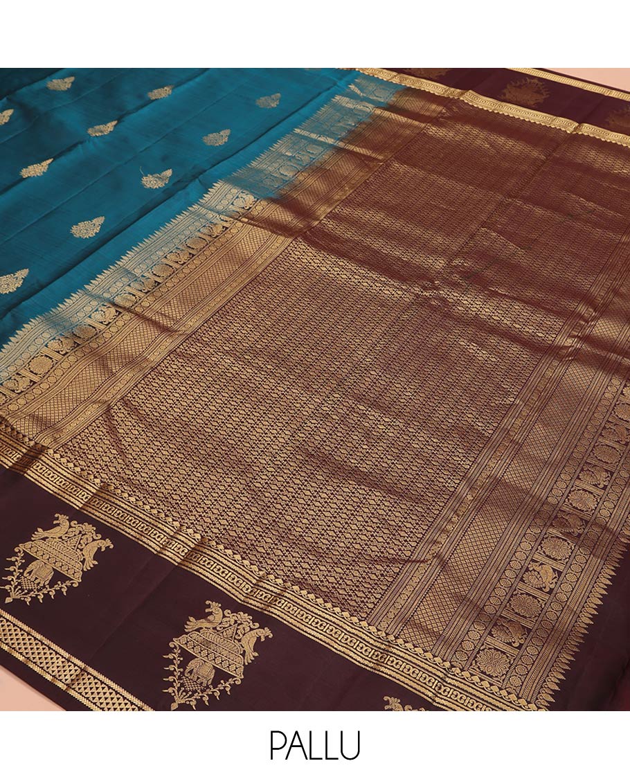 Blue Vasundhara Silk Saree, Elegantly Framed with Zari Buttas All Over Its Body, Complemented by a Contrast Border of Thilakam Mokku, Neli, Kathir, and Ara Maadam Designs, Grand Pallu, and Paired with a Contrast Blouse