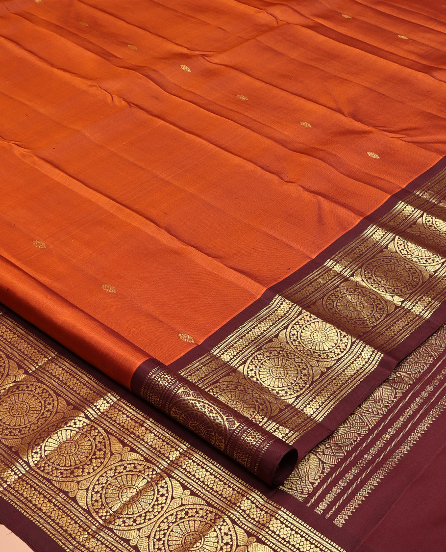Orange Kanchipuram Silk Saree, Showcasing Zari Buttas All Over Its Body, Complemented by a Contrast Border of Muthu, Kathir, Kamalam, and Chakram Designs, Grand Jaal Pallu, and Paired with a Contrast Blouse