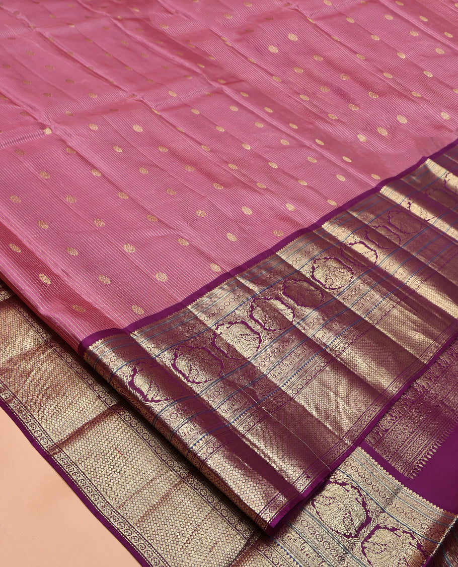 Pink Vasundhara Silk Saree, Elevated with Zari Stripes and Chakram Buttas All Over Its Body, Complemented by a Contrast Border of Rekku, Muthu, Kamalam and Mayil Kann Designs, Grand Geometric Patterned Pallu, and Paired with a Contrast Blouse